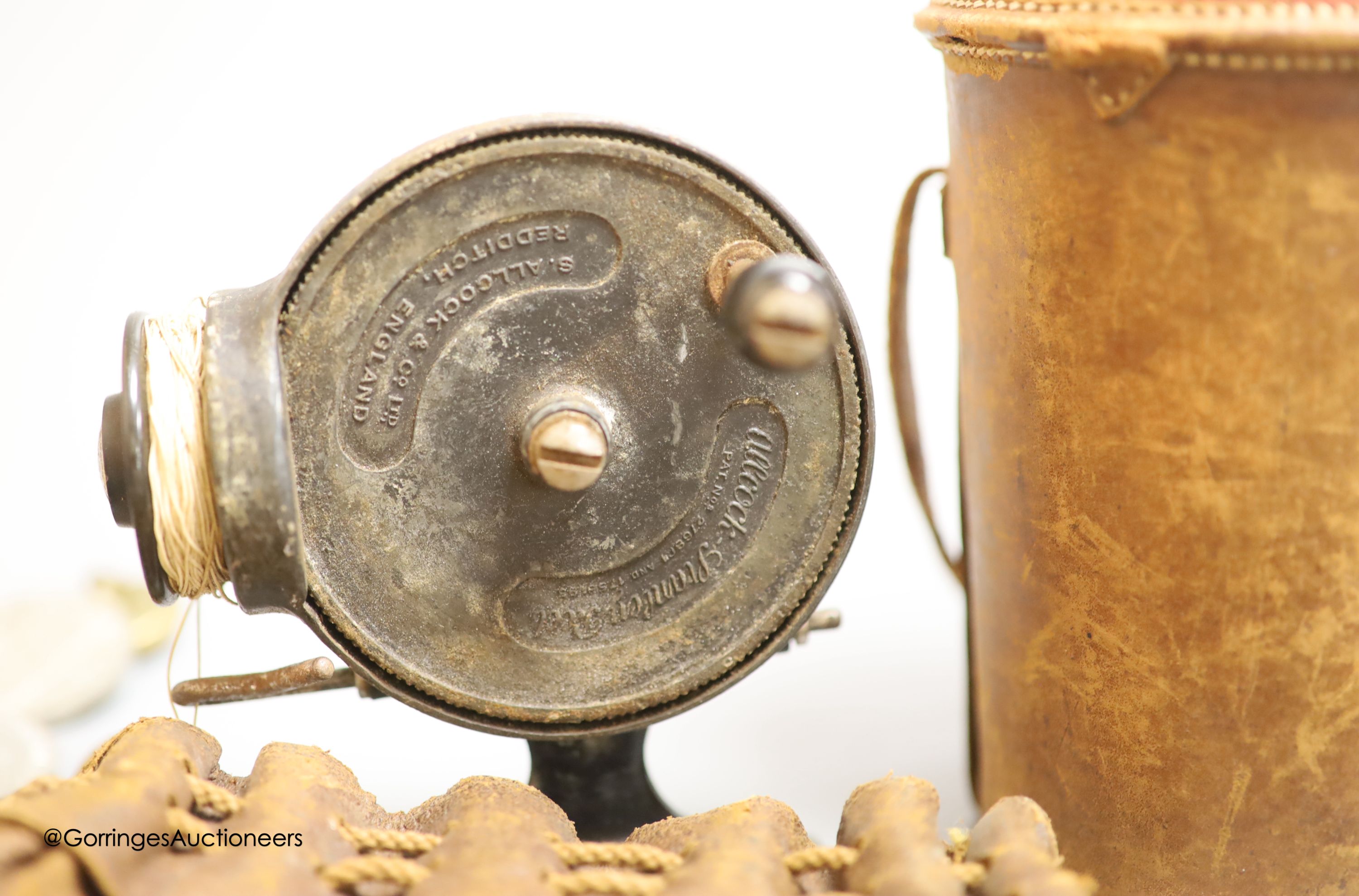 A leather cased flask and cups, various WWI and WWII medals, binoculars and a fishing reel